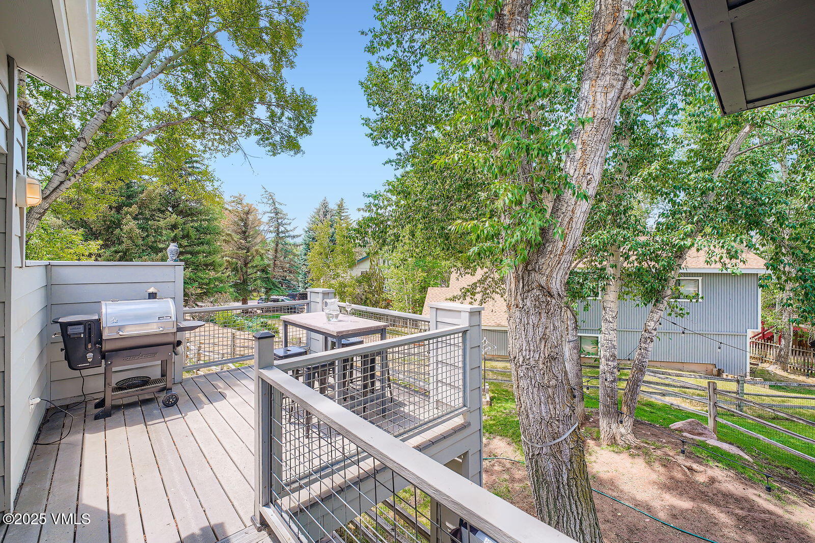 22 Wellington Lane, Unit 2 Edwards, CO 81632 - Photo 8 of 32 a view of a roof deck with table and chairs a barbeque with wooden fence and floor