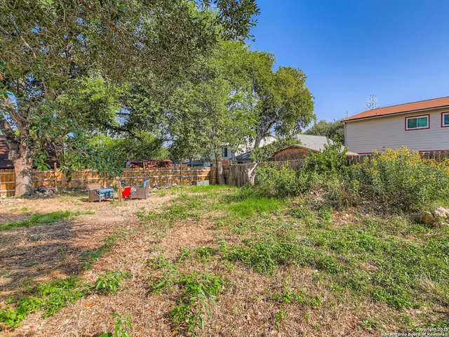 a view of a tree in front of a house