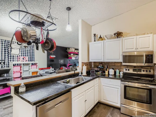 a kitchen that has a lot of appliances and cabinets