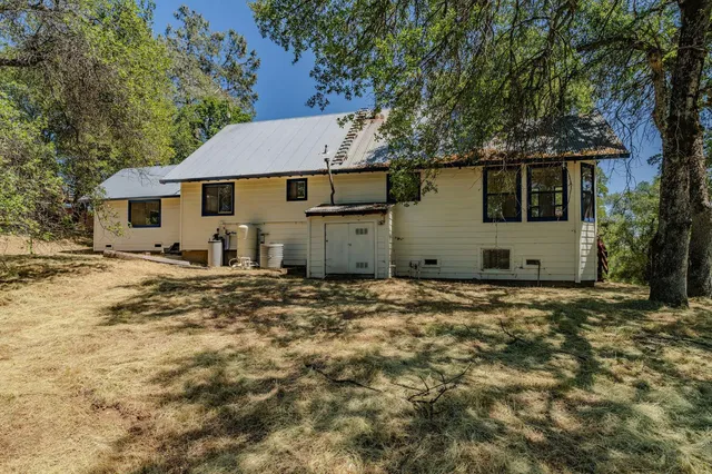 an aerial view of a house with a yard