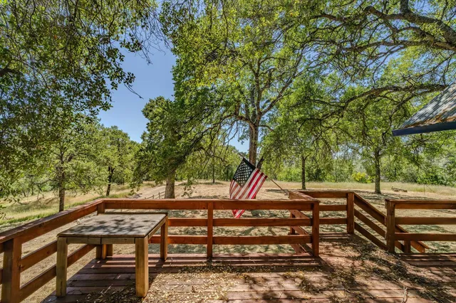 a view of an empty room with wooden fence
