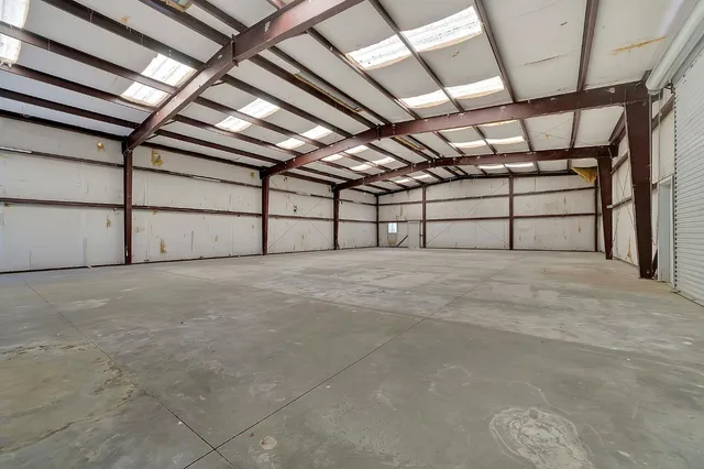 a view of a house with a large window and wooden fence