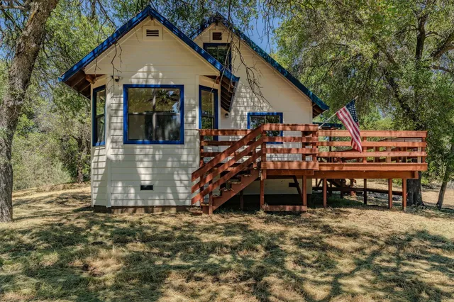 an aerial view of a house with a yard