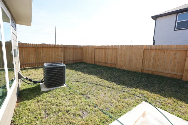 a view of a backyard with wooden fence