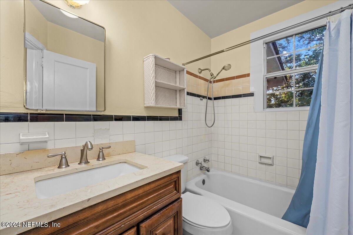 6554 Ortolan Avenue Jacksonville, FL 32216 - Photo 17 of 30 a bathroom with a sink a toilet and shower