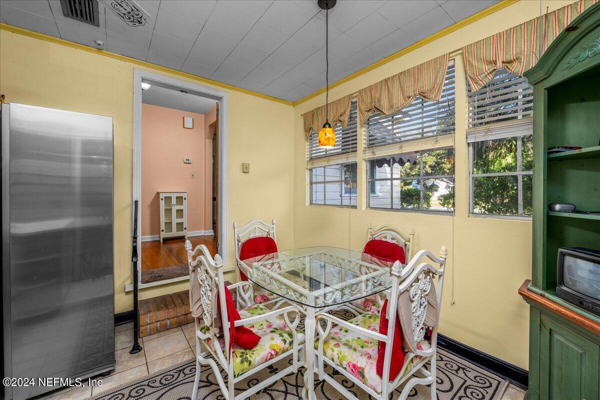 6554 Ortolan Avenue Jacksonville, FL 32216 - Photo 20 of 30 a view of a dining room with furniture a chandelier fan and window