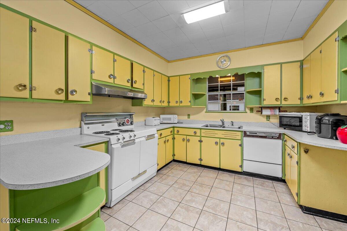 6554 Ortolan Avenue Jacksonville, FL 32216 - Photo 22 of 30 a kitchen with a sink appliances cabinets and a kitchen