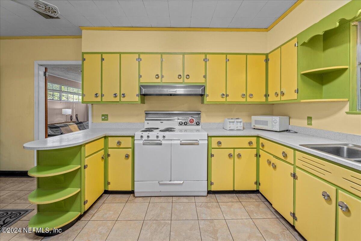 6554 Ortolan Avenue Jacksonville, FL 32216 - Photo 23 of 30 a kitchen with a sink cabinets and a window