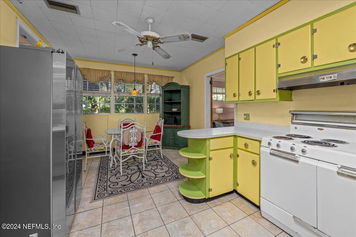 6554 Ortolan Avenue Jacksonville, FL 32216 - Photo 24 of 30 a living room with furniture a flat screen tv and kitchen view