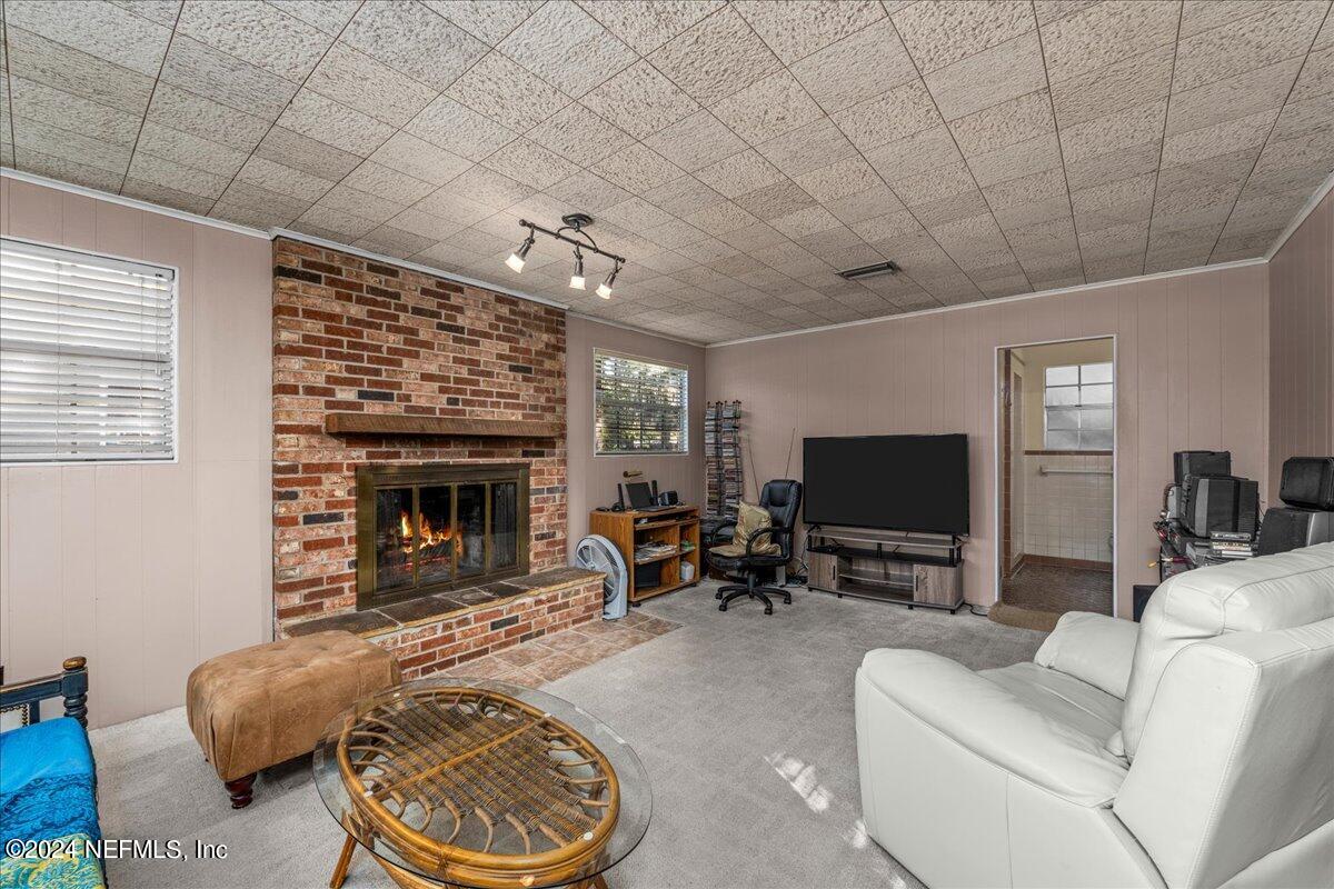 6554 Ortolan Avenue Jacksonville, FL 32216 - Photo 25 of 30 a living room with furniture and a fireplace