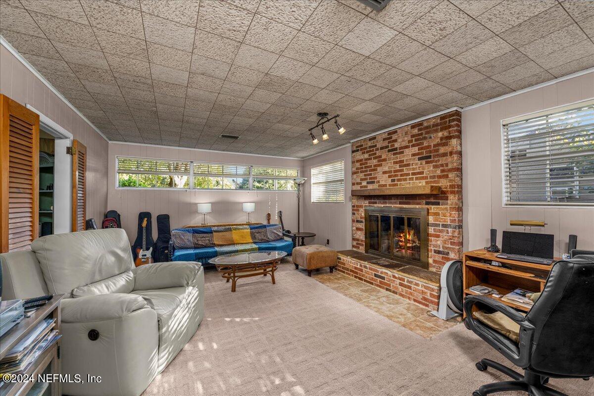 6554 Ortolan Avenue Jacksonville, FL 32216 - Photo 26 of 30 a living room with furniture a fireplace and a table