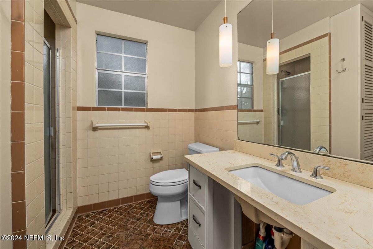 6554 Ortolan Avenue Jacksonville, FL 32216 - Photo 27 of 30 a bathroom with a granite countertop sink toilet and shower