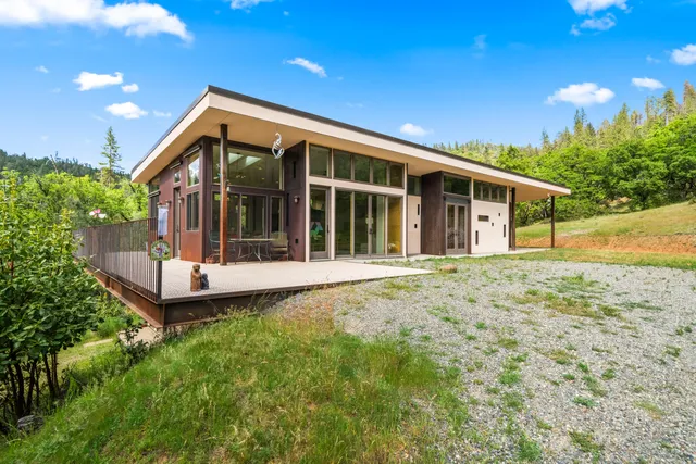 a big room with wooden floor and city view