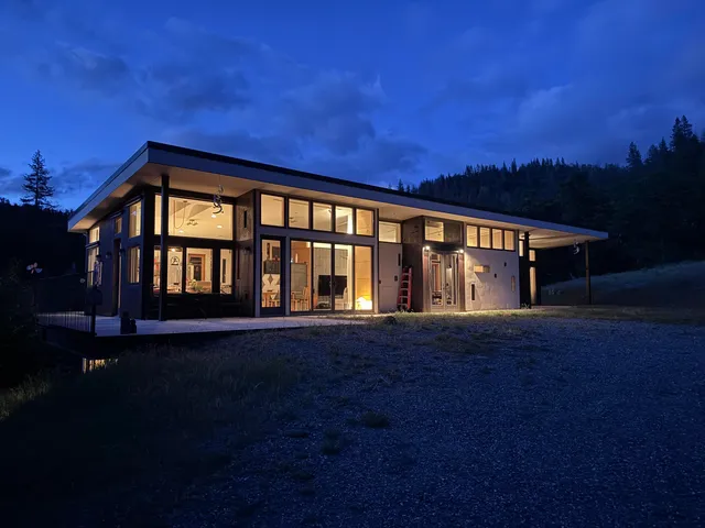 front view of a house with a yard and potted plants