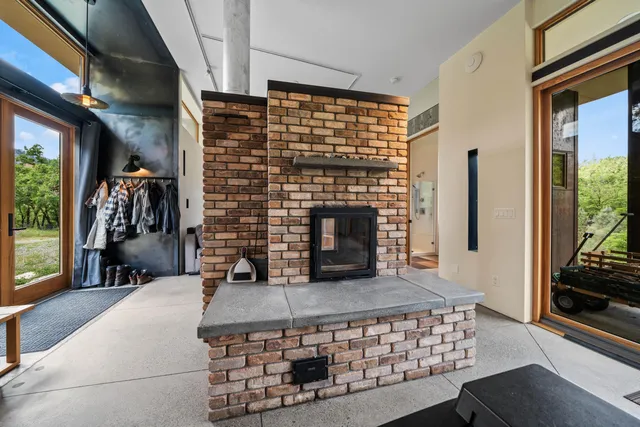 a view of a house with backyard and trees