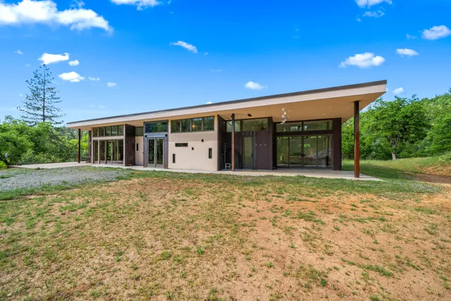 a living room with furniture and large window