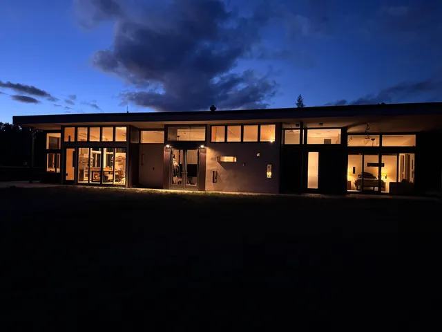 a spacious bedroom with a large bed and a large window