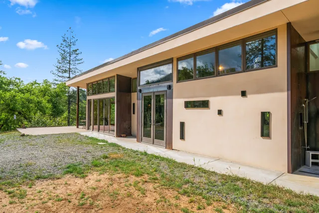 a living room filled with furniture and a large window