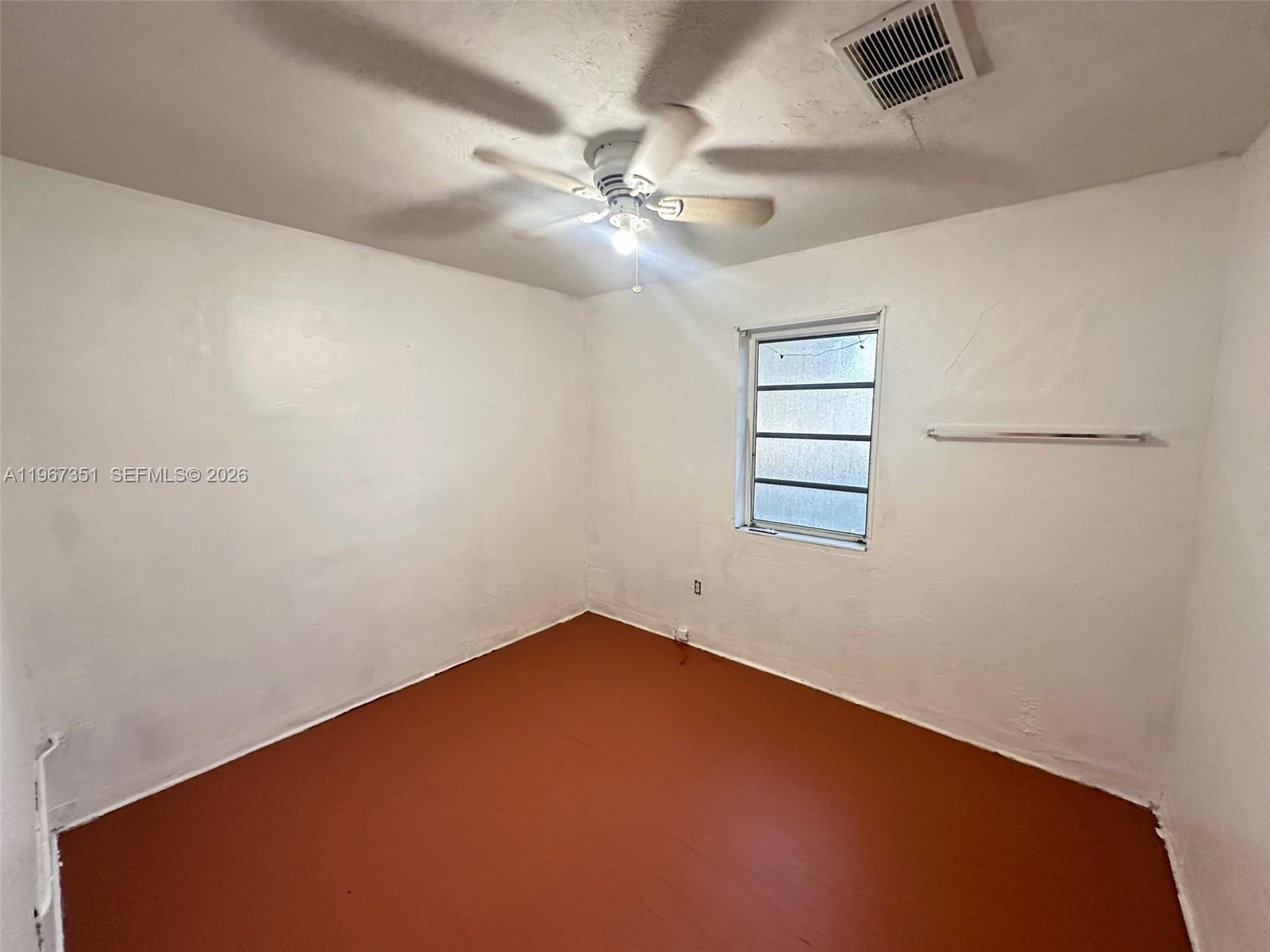1829 Harding Street Hollywood, FL 33020 - Photo 6 of 15 an empty room with windows and ceiling fan