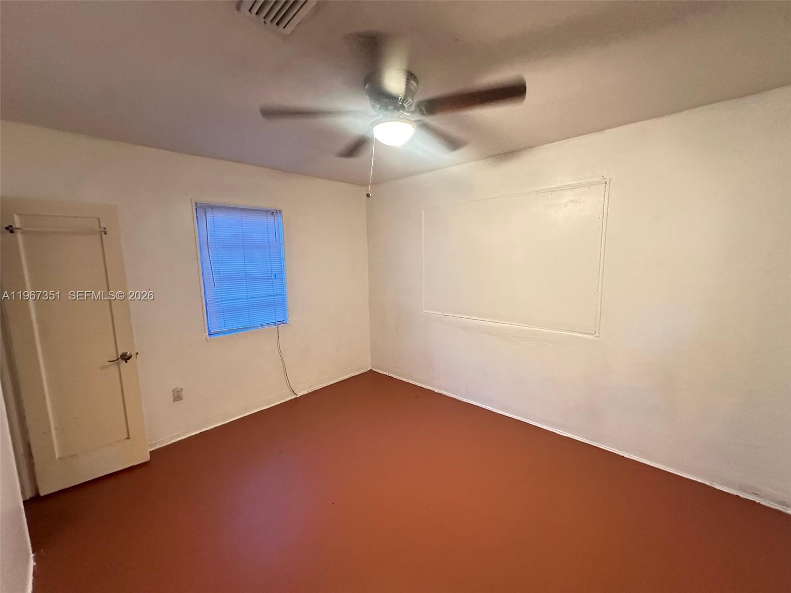 1829 Harding Street Hollywood, FL 33020 - Photo 7 of 15 an empty room with a ceiling fan and a window