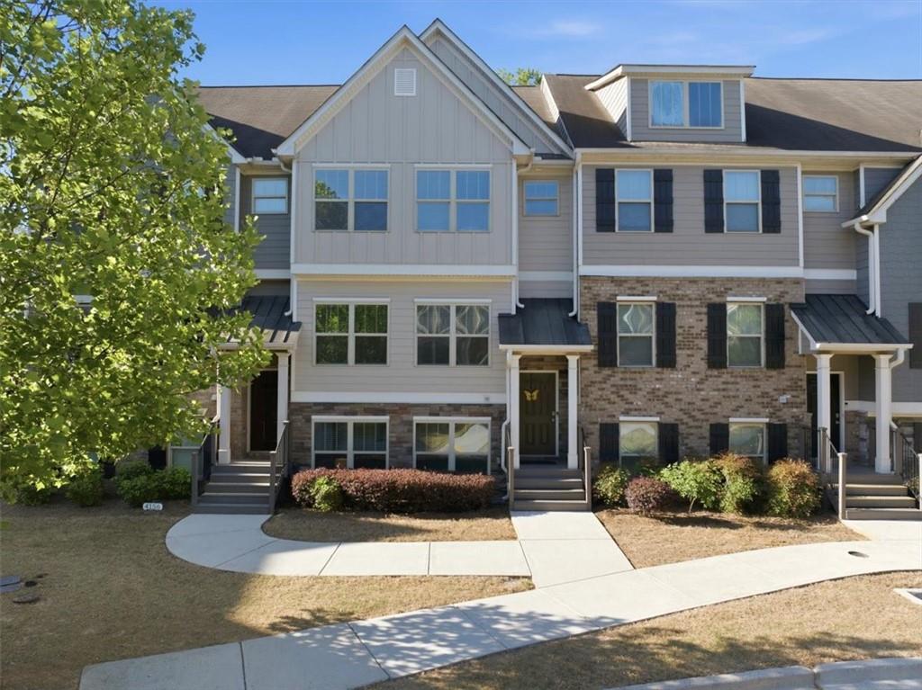 4154 Integrity Way Powder Springs, GA 30127 - Photo 1 of 52 a front view of a building with a yard