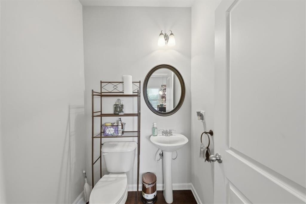 4154 Integrity Way Powder Springs, GA 30127 - Photo 18 of 52 a bathroom with a toilet sink vanity and mirror
