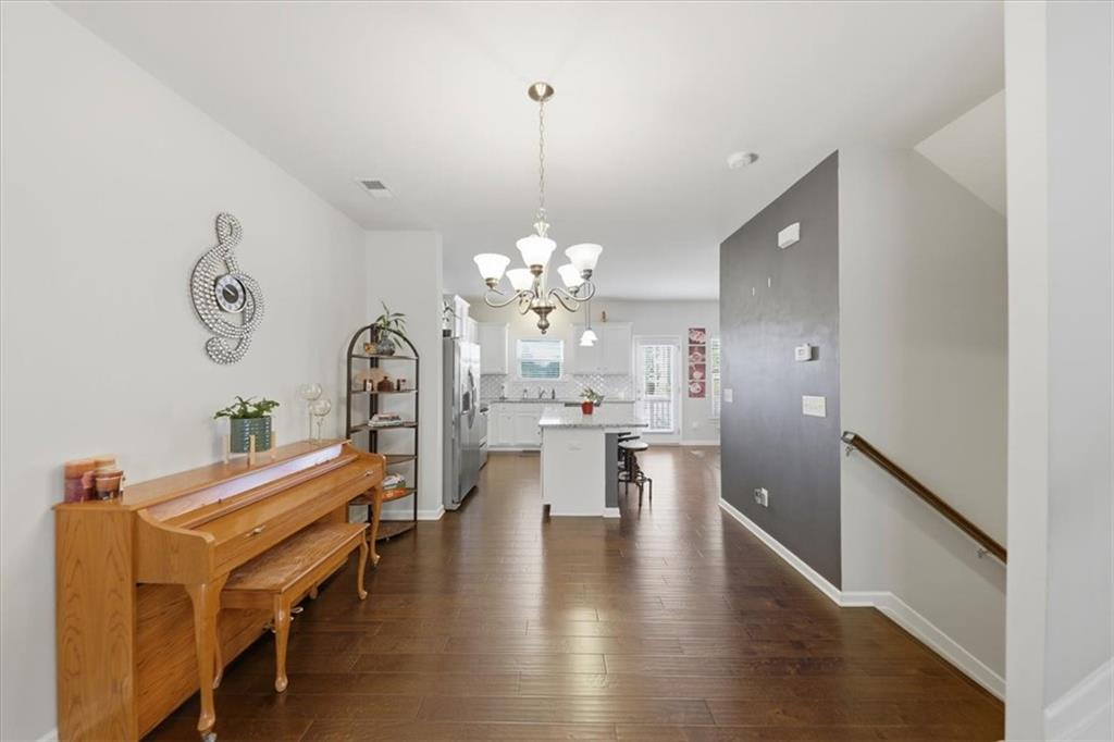 4154 Integrity Way Powder Springs, GA 30127 - Photo 19 of 52 a view of a dining room with furniture and a chandelier