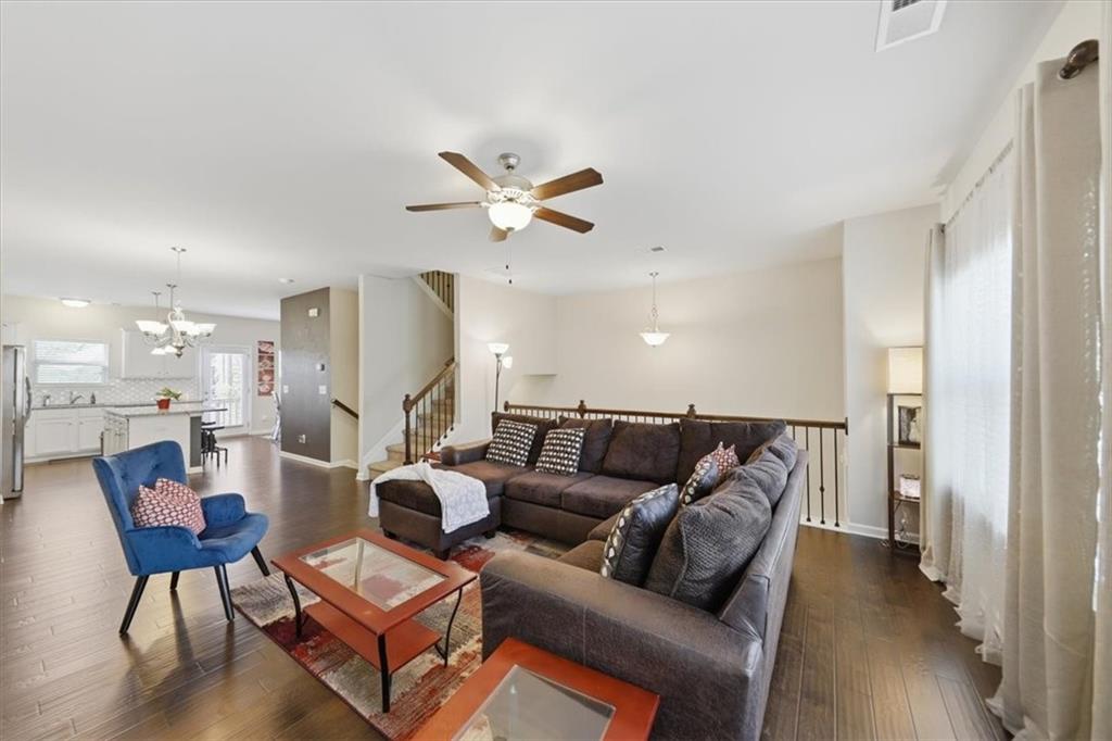 4154 Integrity Way Powder Springs, GA 30127 - Photo 23 of 52 a living room with furniture a ceiling fan and a rug