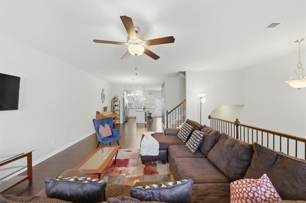 4154 Integrity Way Powder Springs, GA 30127 - Photo 24 of 52 a living room with furniture and a chandelier