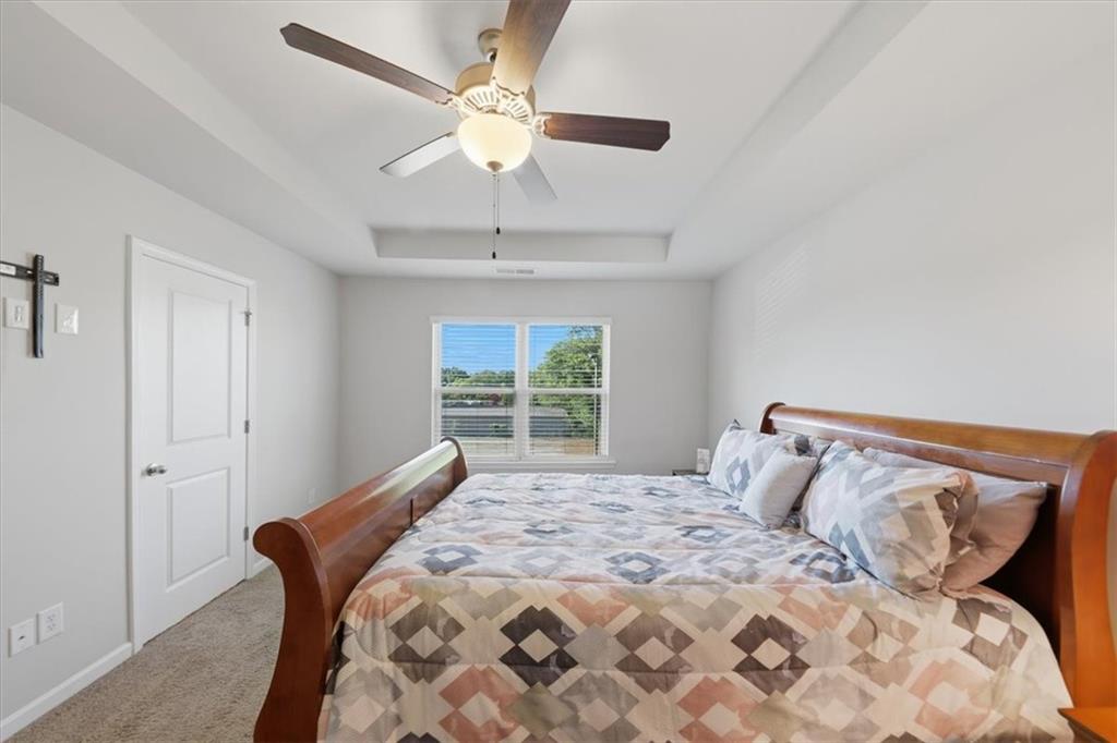 4154 Integrity Way Powder Springs, GA 30127 - Photo 27 of 52 a bedroom with a large bed and a window