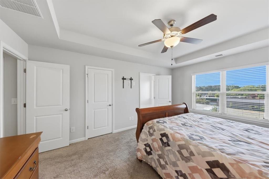 4154 Integrity Way Powder Springs, GA 30127 - Photo 28 of 52 a bedroom with a large bed and a chandelier