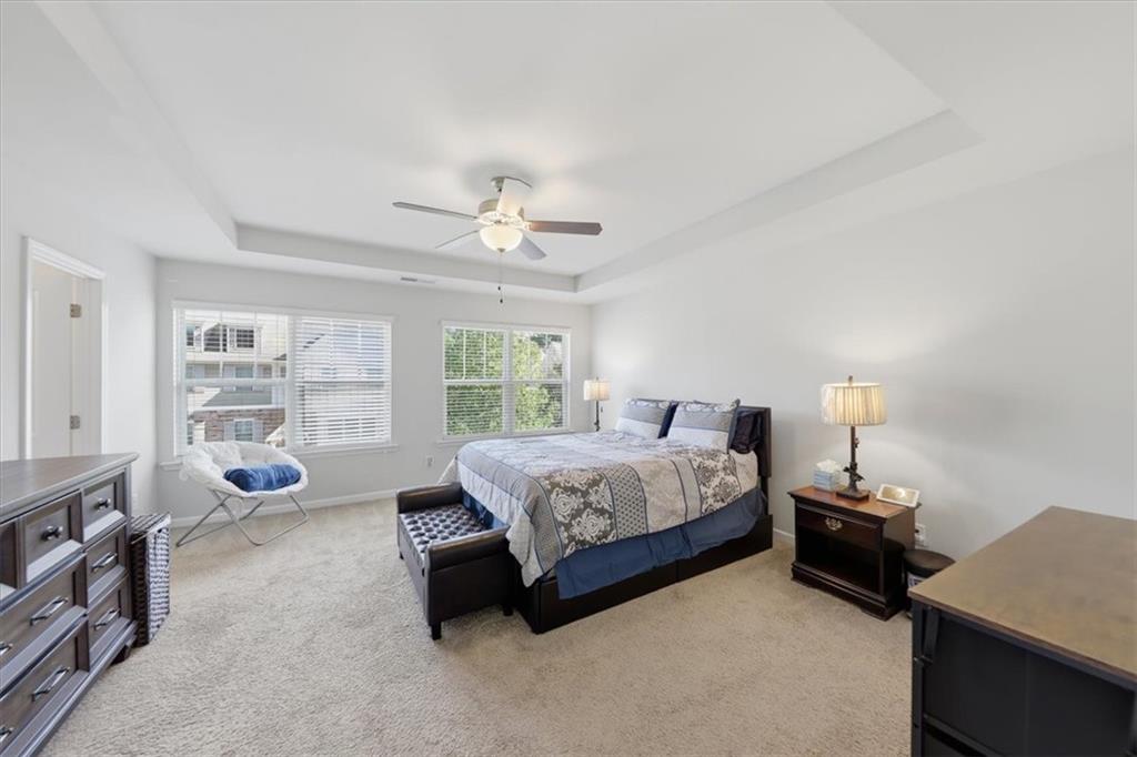 4154 Integrity Way Powder Springs, GA 30127 - Photo 34 of 52 a spacious bedroom with a bed a couch and large window