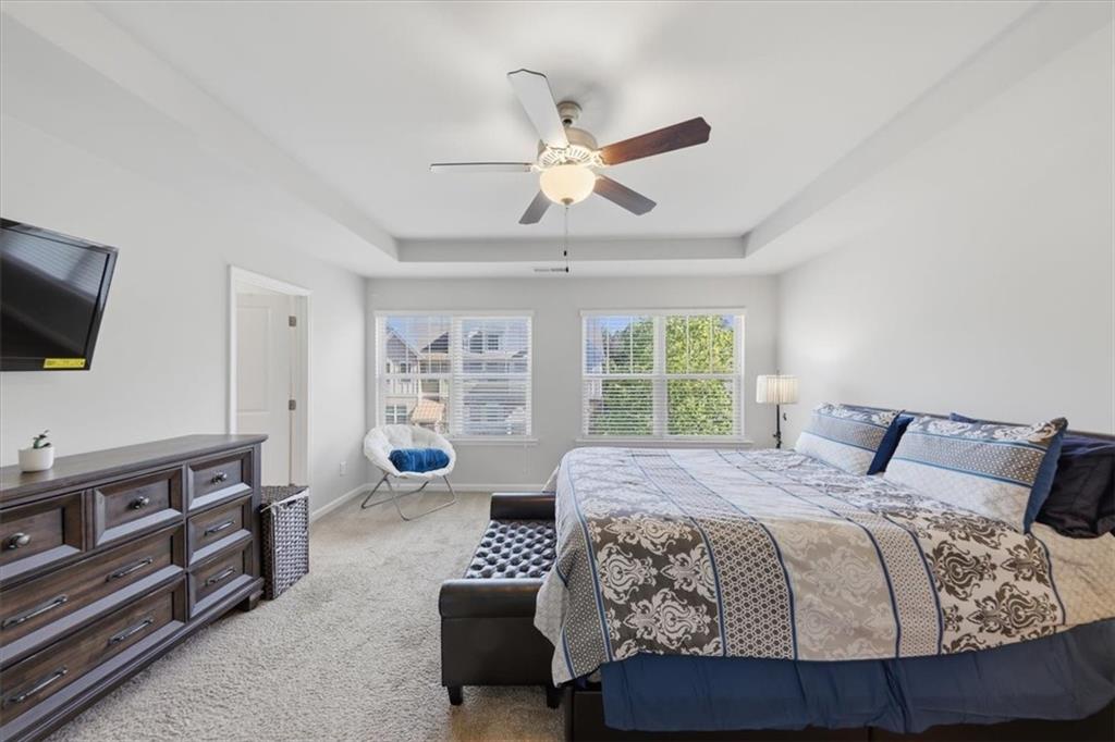 4154 Integrity Way Powder Springs, GA 30127 - Photo 35 of 52 a bedroom with a bed and flat screen tv