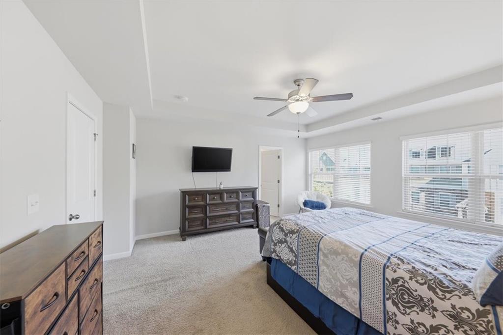 4154 Integrity Way Powder Springs, GA 30127 - Photo 36 of 52 a spacious bedroom with a bed and a flat screen tv