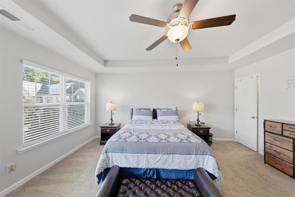4154 Integrity Way Powder Springs, GA 30127 - Photo 37 of 52 a bedroom with a large bed and a chandelier fan