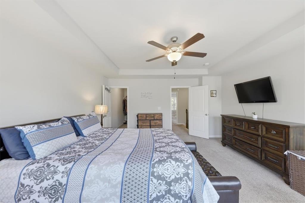 4154 Integrity Way Powder Springs, GA 30127 - Photo 38 of 52 a bedroom with a bed and a flat screen tv