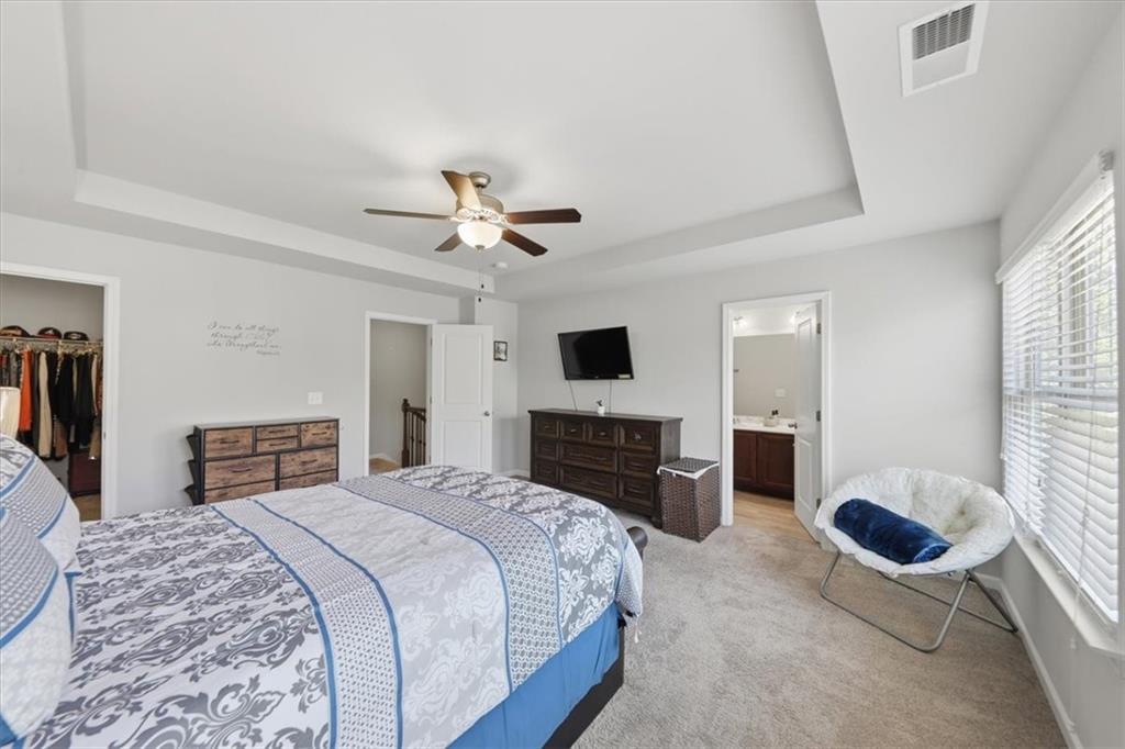 4154 Integrity Way Powder Springs, GA 30127 - Photo 39 of 52 a bedroom with a large bed and a fireplace