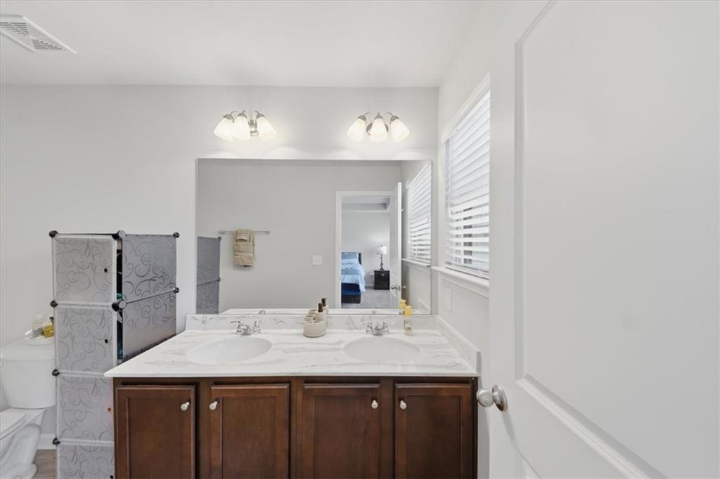 4154 Integrity Way Powder Springs, GA 30127 - Photo 40 of 52 a bathroom with a granite countertop sink and a mirror