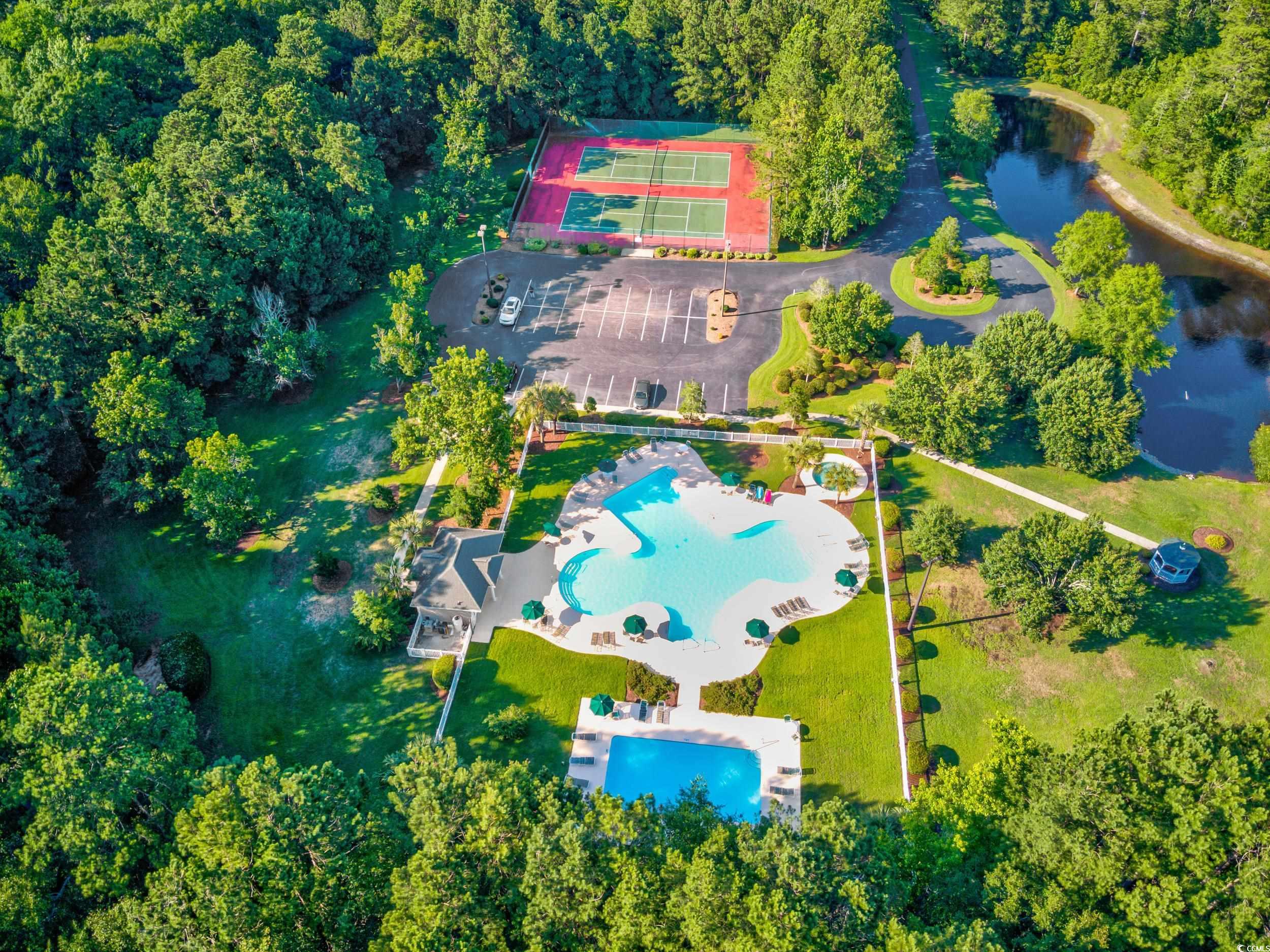 117 Pinehurst Lane, Unit 5E Pawleys Island, SC 29585 - Photo 22 of 40 Aerial view of a pool and a nearby body of water