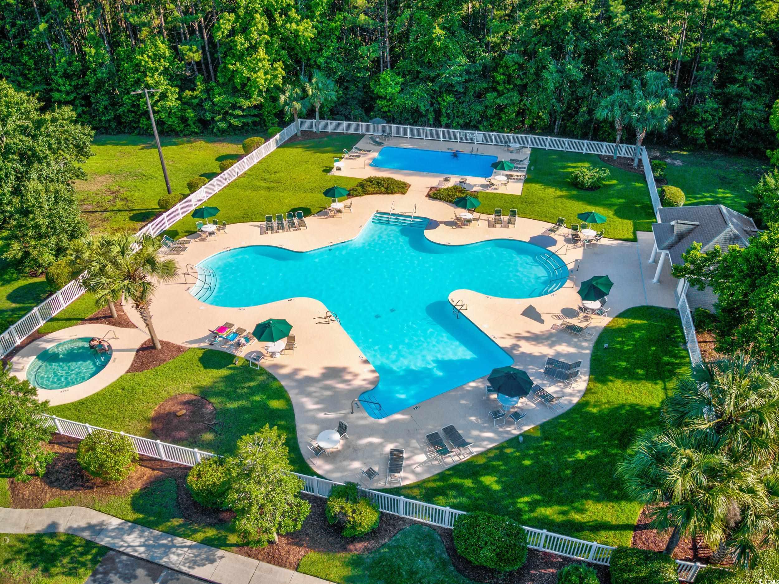 117 Pinehurst Lane, Unit 5E Pawleys Island, SC 29585 - Photo 23 of 40 Community pool featuring a patio area