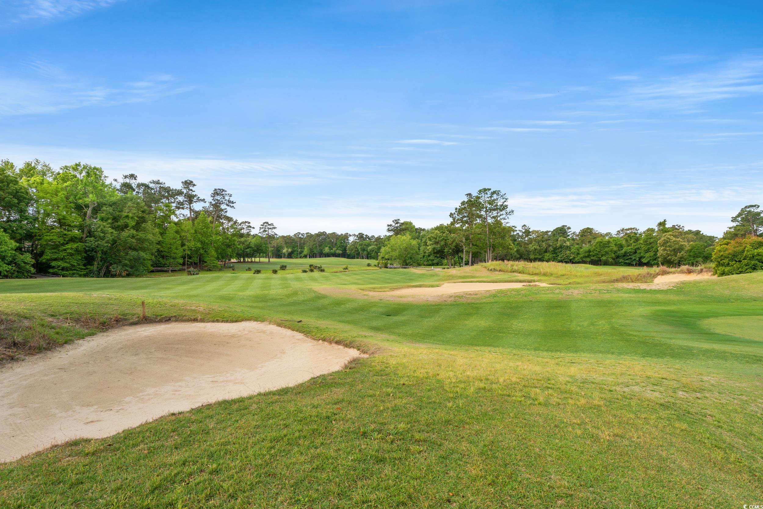 117 Pinehurst Lane, Unit 5E Pawleys Island, SC 29585 - Photo 35 of 40 View of property's community with golf course view, view of wooded area, and a lawn