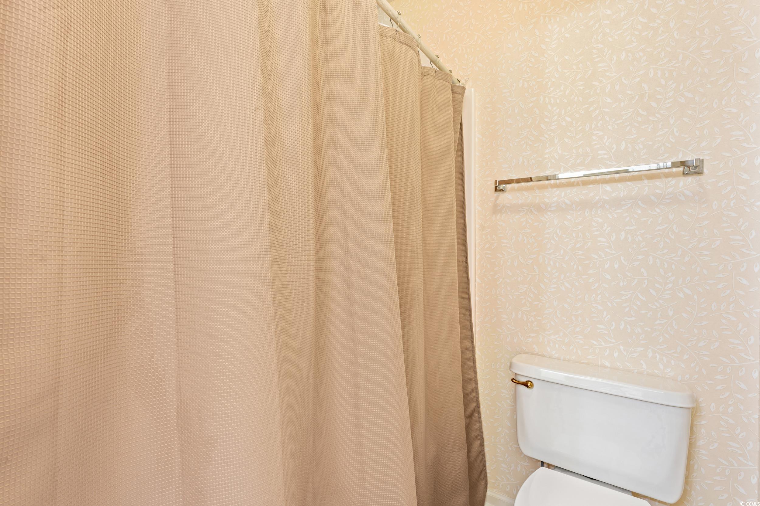 117 Pinehurst Lane, Unit 5E Pawleys Island, SC 29585 - Photo 6 of 40 Full bath featuring wallpapered walls and a shower with curtain