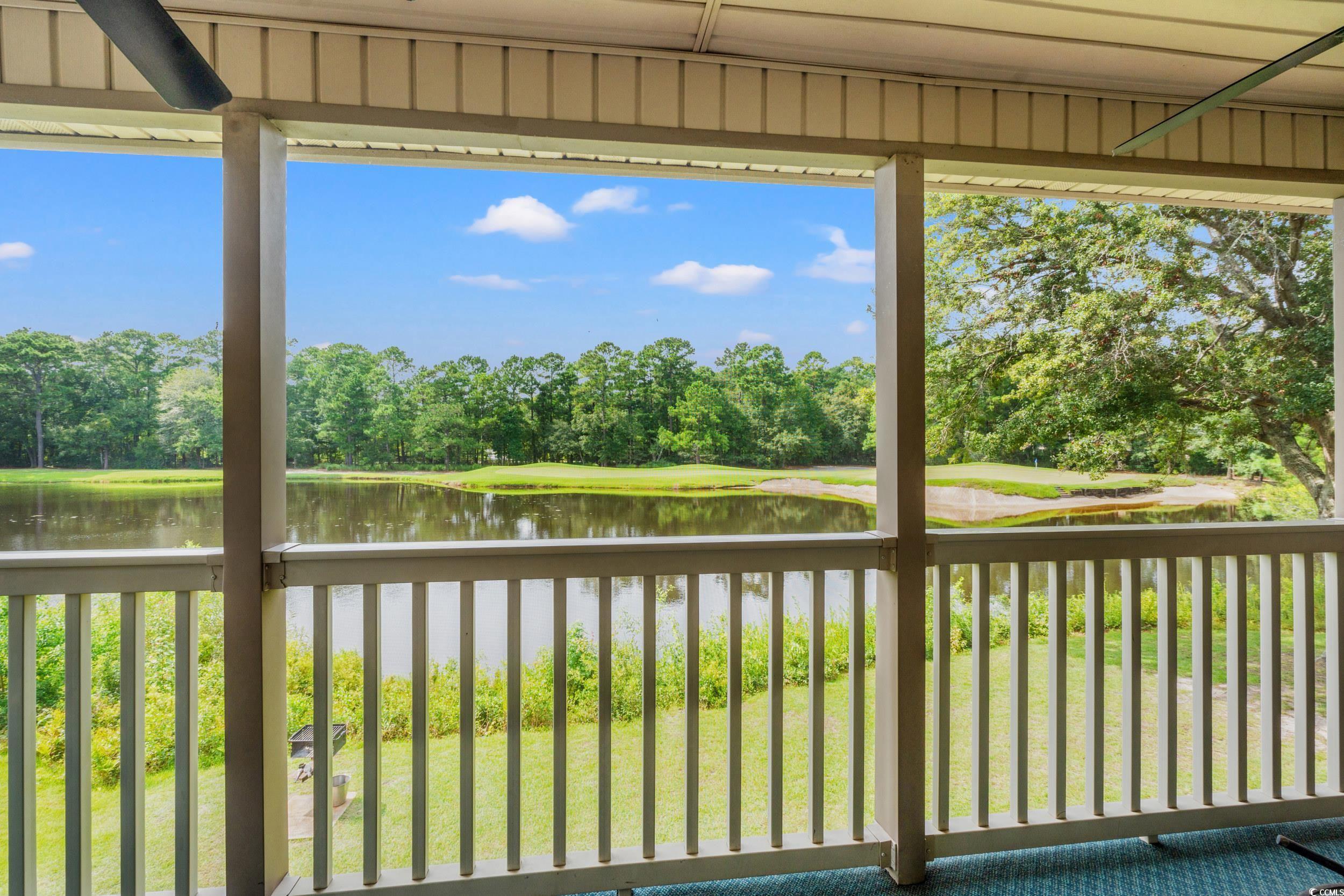 117 Pinehurst Lane, Unit 5E Pawleys Island, SC 29585 - Photo 9 of 40 Unfurnished sunroom with view of wooded area and a water view