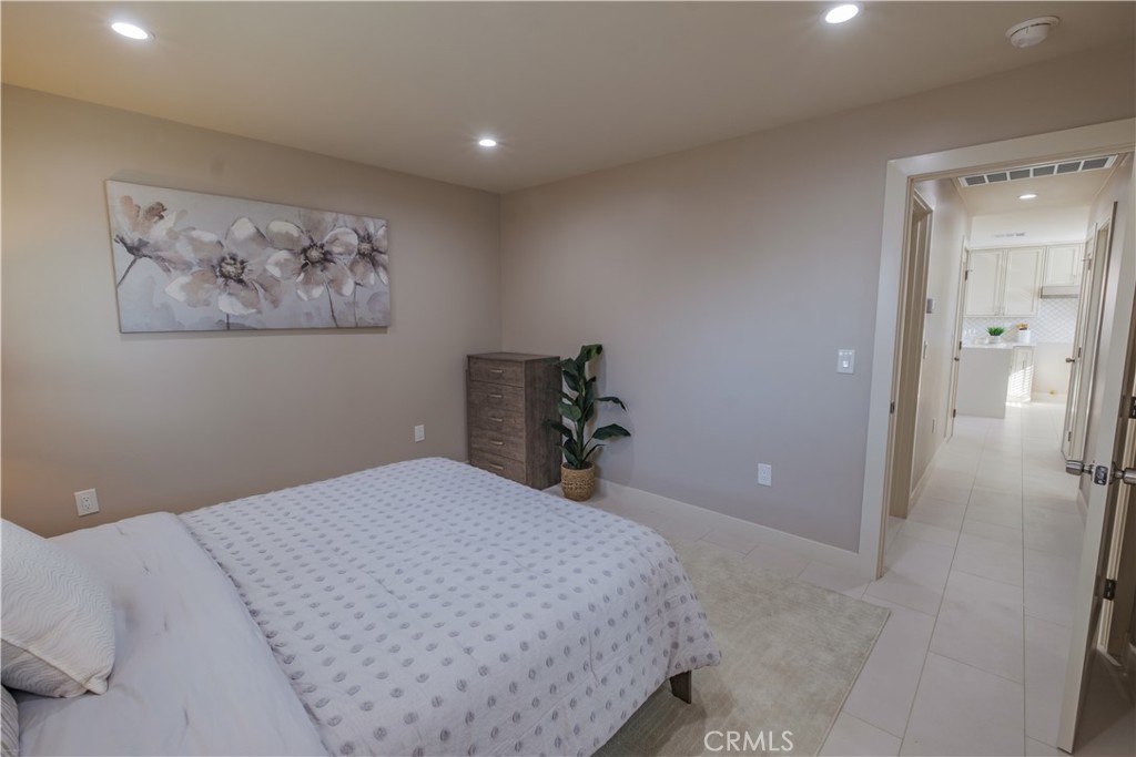 223 South Aprilia Avenue Compton, CA 90220 - Photo 41 of 46 a bedroom with a bed and a painting on the wall