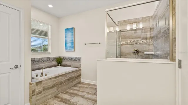 a bathroom with a bathtub and shower