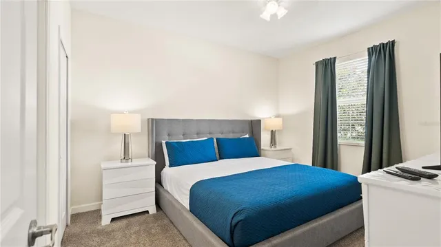 a bedroom with a bed and a large mirror