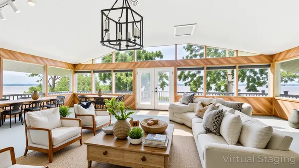 a bedroom with a large bed and a chandelier