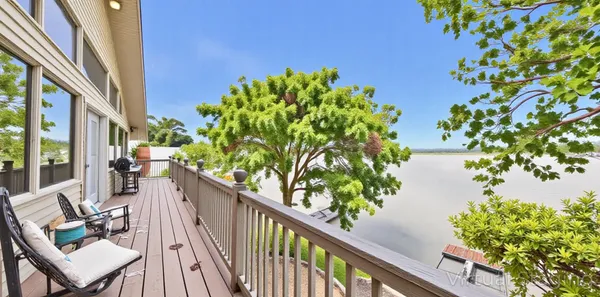 a living room with furniture kitchen view and a large window