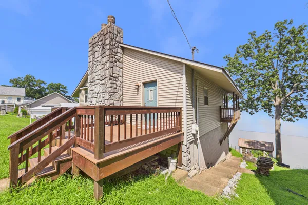 a kitchen with stainless steel appliances a sink a stove a refrigerator cabinets and furniture