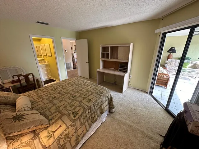 a bedroom with a bed next to a window
